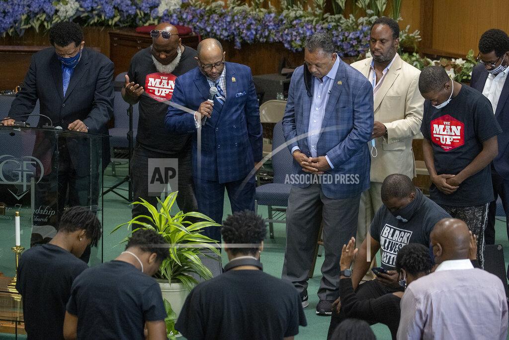 The Rev. Jesse L. Jackson, center right, is surrounded by faith leaders as they stand in prayer after he spoke to send a message of solidarity and demand justice in the death of George Floyd, at Greater Friendship Missionary Baptist Church, Thursday, May 28, 2020 in Minneapolis. (Elizabeth Flores/Star Tribune via AP)