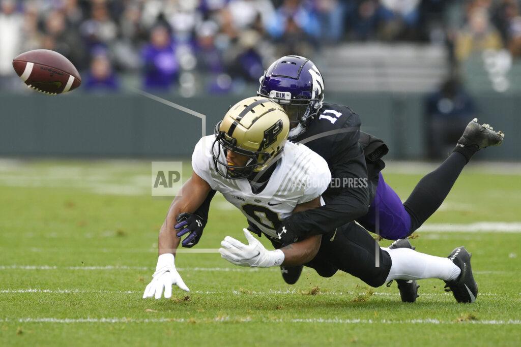Paul Beaty Purdue wide receiver Milton Wright (0) misses a pass as Northwestern's AJ Hampton Jr. (11) defends during the first half of an NCAA college football game, Saturday, Nov. 20, 2021 at Wrigley Field in Chicago. (AP Photo/Paul Beaty)