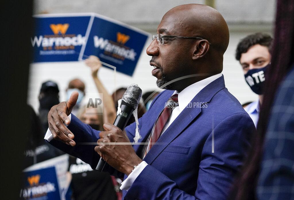 Brynn Anderson Democratic candidate for Senate Raphael G. Warnock speaks to a crowd during a "Get Out the Early Vote" event at the SluttyVegan ATL restaurant on Tuesday, Oct. 27, 2020, in Jonesboro, Ga. (AP Photo/Brynn Anderson)