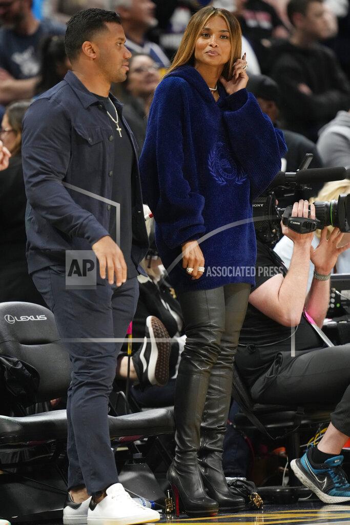 David Zalubowski Denvber Broncos quarterback Russell Wilson, left, stands with his wife, rap star Ciara, in the second half of Game 4 of an NBA basketball first-round Western Conference playoff series as the Denver Nuggets host the Golden State Warriors, Sunday, April 24, 2022, in Denver. (AP Photo/David Zalubowski)