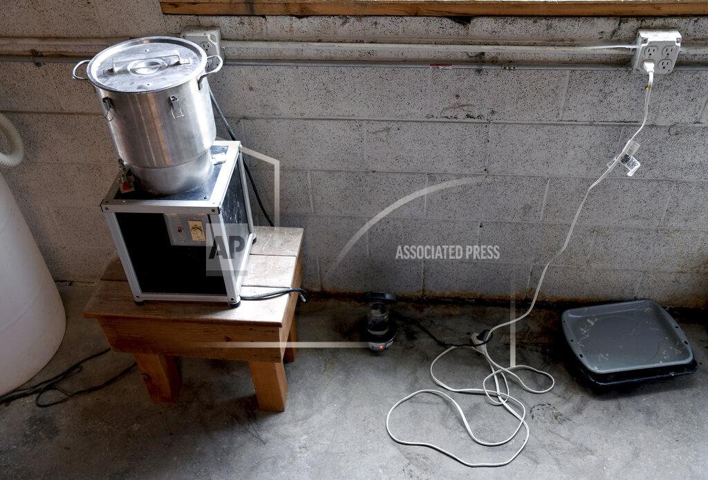 Thomas Peipert In this Wednesday, Aug. 11, 2021, photo, a cremulator at The Natural Funeral'sFuneral's human body composting facility in Arvada, Colo. On Sept. 7, Colorado became the second state after Washington to allow human body composting, and Oregon will allow the practice beginning next July. Vessels will be packed with wood chips and straw and will compost a body in six months. About three months into the process, the vessel is opened, and the "soil" is filtered for any medical devices like prosthetics, pacemakers, or joint replacements. The remaining large bones are then pulverized by the cremulator and returned to the vessel. (AP Photo/Thomas Peipert)