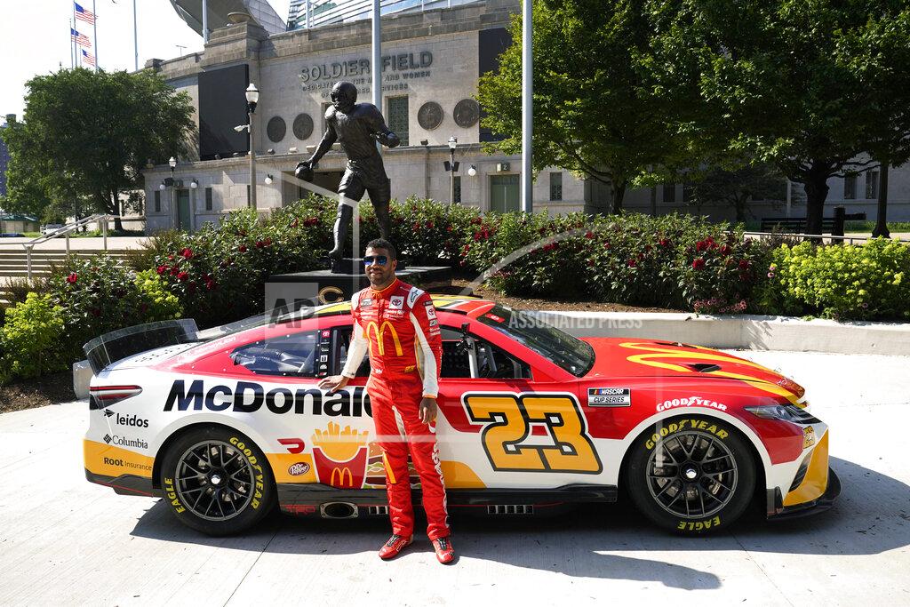 Charles Rex Arbogast NASCAR driver Bubba Wallace poses for photos outside Soldier Field, near the Walter Payton statue, Tuesday, July 19, 2022, in Chicago during a promotional visit to announce a Cup Series street race in the city, to be held July 2, 2023. (AP Photo/Charles Rex Arbogast)