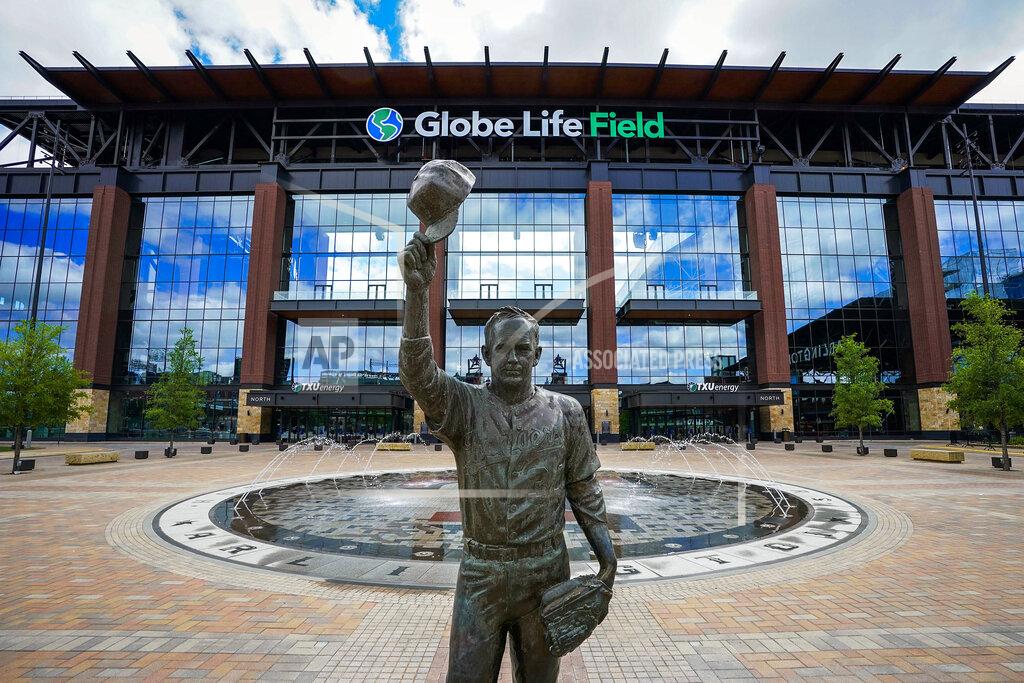 FILE - In this March 31, 2020, file photo, a statue of Nolan Ryan stands in the empty plaza outside Globe Life Field in Arlington, Texas. The new Texas Rangers ballpark is among possible venues Major League Baseball could use if it decides to start the season with groups of teams in different areas. Among the different plans looked at by Major League Baseball is to use Texas as a mid-American hub. (Smiley N. Pool/The Dallas Morning News via AP, Pool, File)