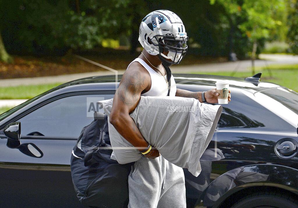 Jeff Siner Carolina Panthers linebacker Denzel Perryman has his hand full as he arrives at NFL football training camp, Tuesday, July 27, 2021, at Wofford College in Spartanburg, S.C. (Jeff Siner/The Charlotte Observer via AP)