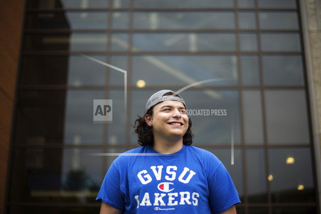 Kendra Stanley-Mills In this image provided by Grand Valley State University, Jordan Bernal, a Sport Management student at Grand Valley State University, poses outside Kindschi Hall of Science in Allendale, Mich. on Sept. 1, 2020. Bernal said first-generation college students like himself often struggle to find and take advantage of resources and scholarships once they enroll. (Kendra Stanley-Mills/ Grand Valley State University via AP)