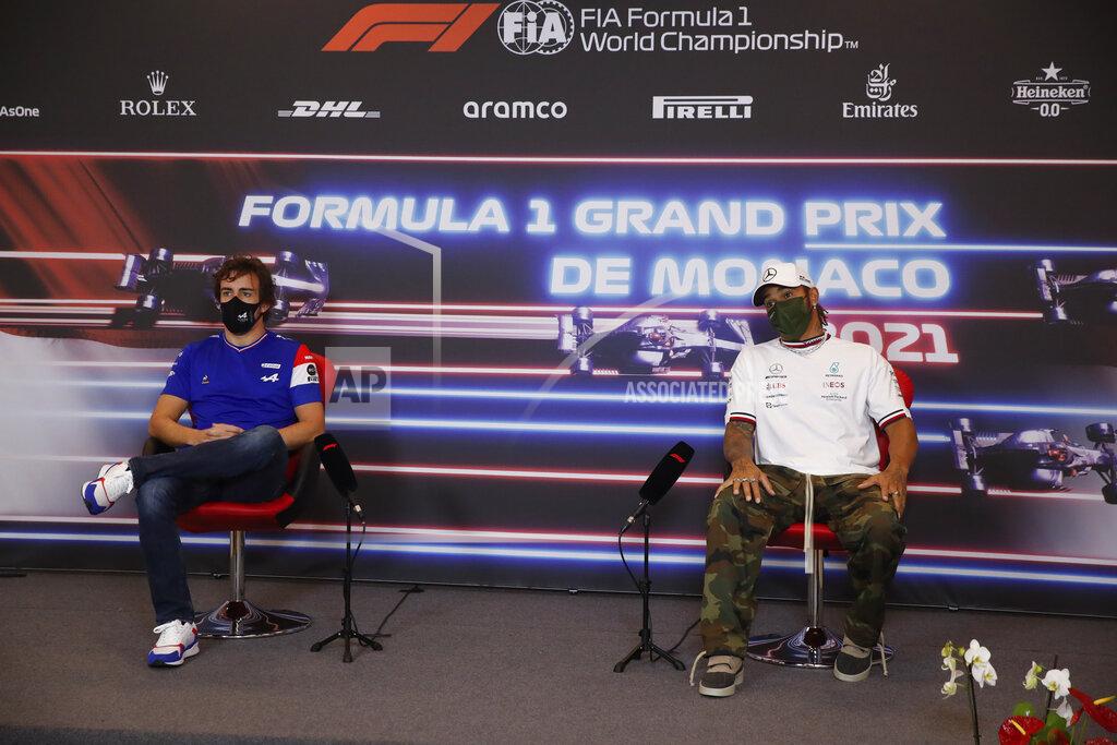 Sebastian Nogier Alpine driver Fernando Alonso of Spain, left, sits by Mercedes driver Lewis Hamilton of Britain during a press conference ahead of Sunday's Formula One race, in Monaco, Wednesday, May 19, 2021. (Sebastian Nogier, Pool via AP)