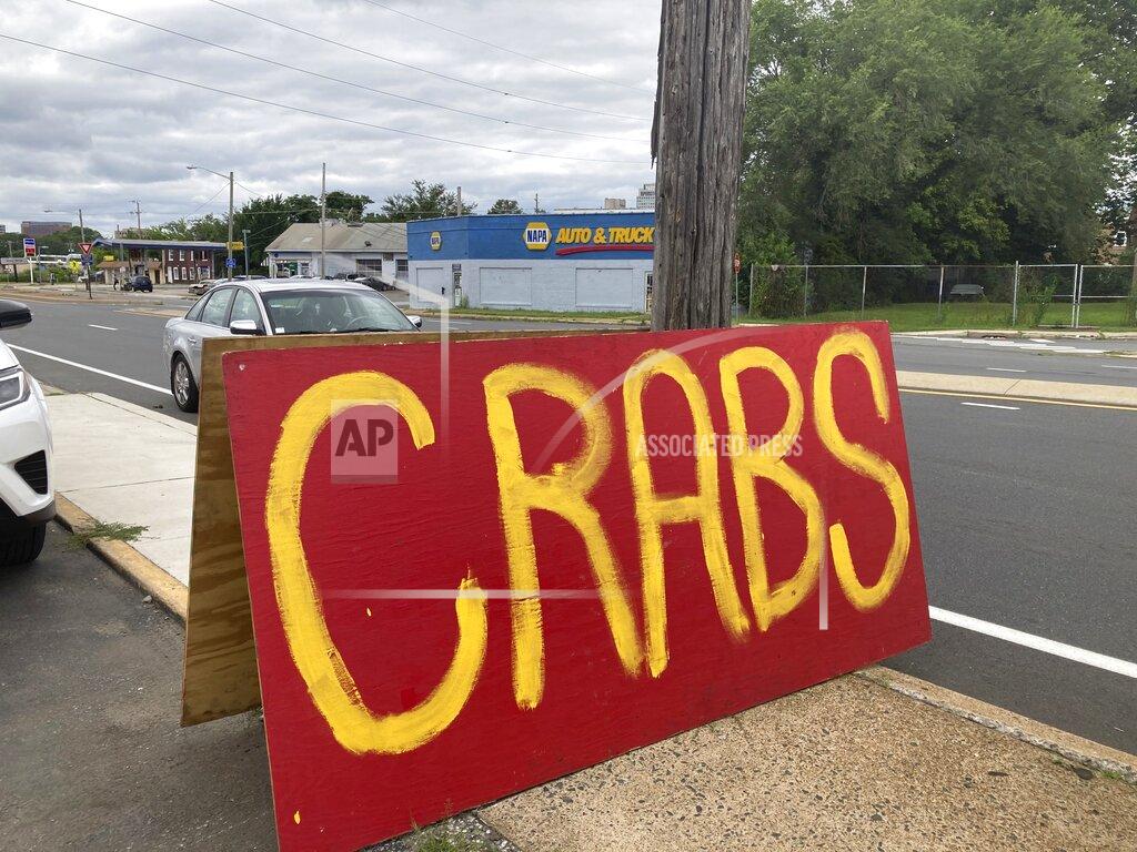 José Ignacio Castañeda A hand-painted sign attracts passing drivers at the grand opening of the Crab Cravers food truck in Wilmington, Delaware, on Sunday, July 18, 2021. (José Ignacio Castañeda /The News Journal via AP)
