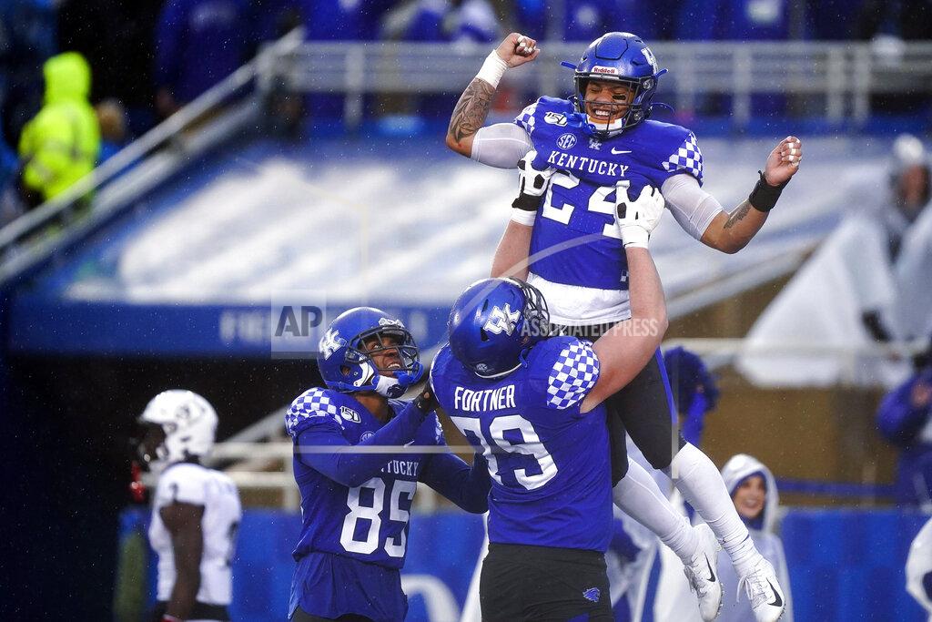 Bryan Woolston Kentucky running back Christopher Rodriguez Jr. (24) celebrates with offensive tackle Luke Fortner (79) and wide receiver Bryce Oliver (85) after scoring a touchdown during the second half of the NCAA college football game against Louisville, Saturday, Nov. 30, 2019, in Lexington, Ky. (AP Photo/Bryan Woolston)