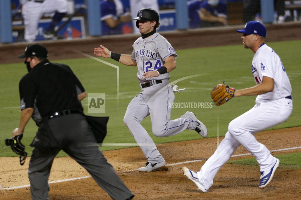Alex Gallardo Colorado Rockies' Ryan McMahon, center, races home to score on a wild pitch by Los Angeles Dodgers reliever Blake Treinen, right, during the seventh inning of a baseball game in Los Angeles, Saturday, Aug. 22, 2020. (AP Photo/Alex Gallardo)