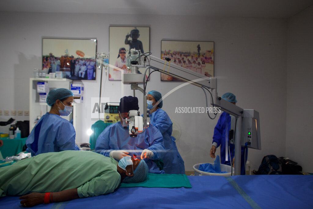 Bikram Rai Nepal’s “God of Sight”, Dr. Sanduk Ruit performs a simple surgical technique to remove cataracts at an eye camp in Lumbini, 288 kilometers (180 miles) south west of Kathmandu, Nepal, March 31, 2021. The eye doctor renowned for his innovative and inexpensive cataract surgery for the poor is taking his work beyond the Himalayan mountains to other parts of the world so there is no more unnecessary blindness in the world. Ruit, who has won many awards for his work and performed some 130,000 cataract surgery in the past three decades, is aiming to expand his work beyond the borders of his home country and the region to go globally. (AP Photo/Bikram Rai)