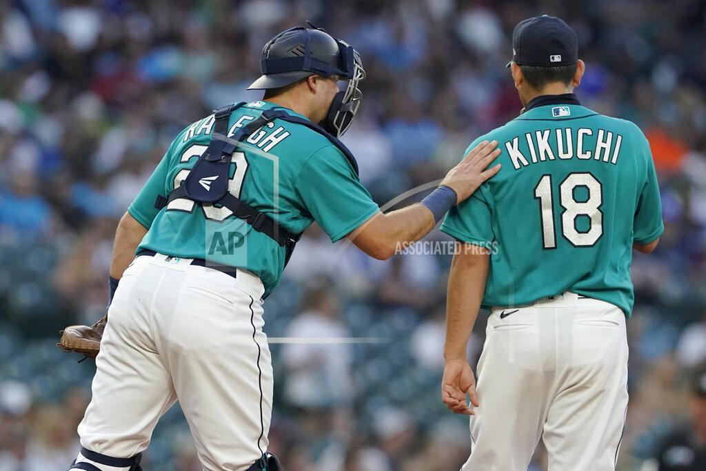 Ted S. Warren Seattle Mariners catcher Cal Raleigh, left, talks with starting pitcher Yusei Kikuchi during the fourth inning of the team's baseball game against the Oakland Athletics, Friday, July 23, 2021, in Seattle. (AP Photo/Ted S. Warren)
