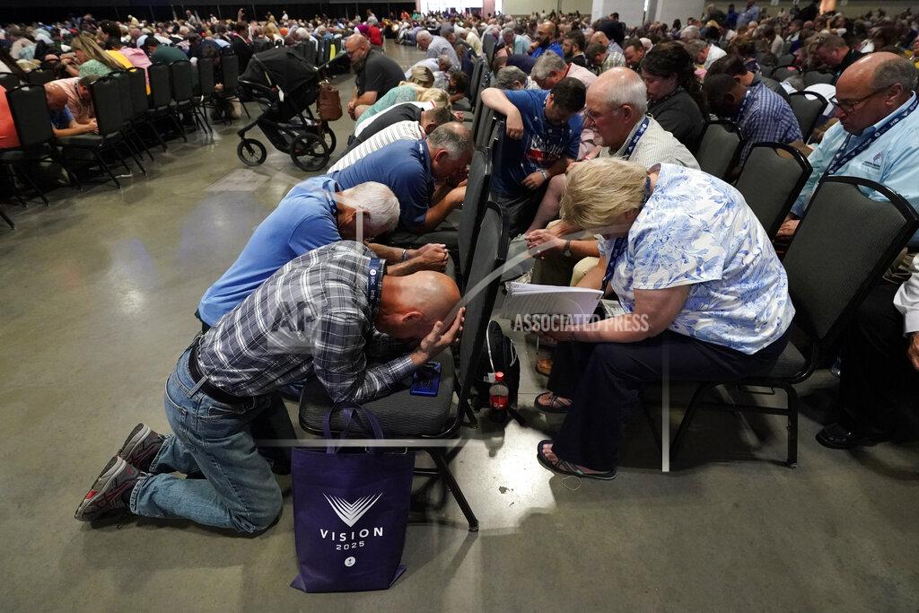 Mark Humphrey People pray during the annual Southern Baptist Convention meeting Tuesday, June 15, 2021, in Nashville, Tenn. (AP Photo/Mark Humphrey)