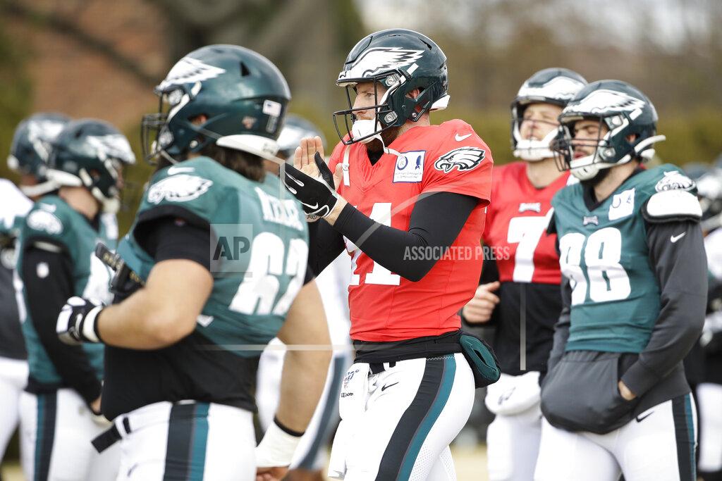 Matt Rourke Philadelphia Eagles quarterback Carson Wentz, center, gathers with his teammates at the NFL football team's practice facility in Philadelphia, Thursday, Dec. 5, 2019. (AP Photo/Matt Rourke)