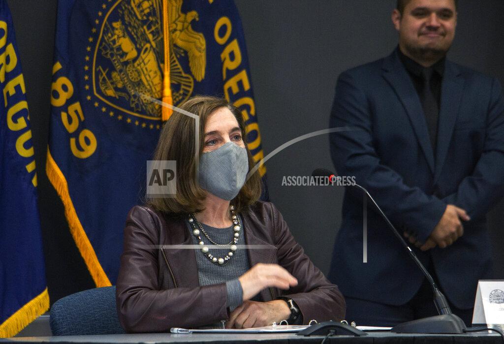 Oregon Gov. Kate Brown attends a news conference Tuesday, Nov. 10, 2020, in Portland, Ore. Brown and Oregon health officials warned Tuesday of the capacity challenges facing hospitals as COVID-19 case counts continue to spike in the state. (Cathy Cheney/Pool Photo via AP)