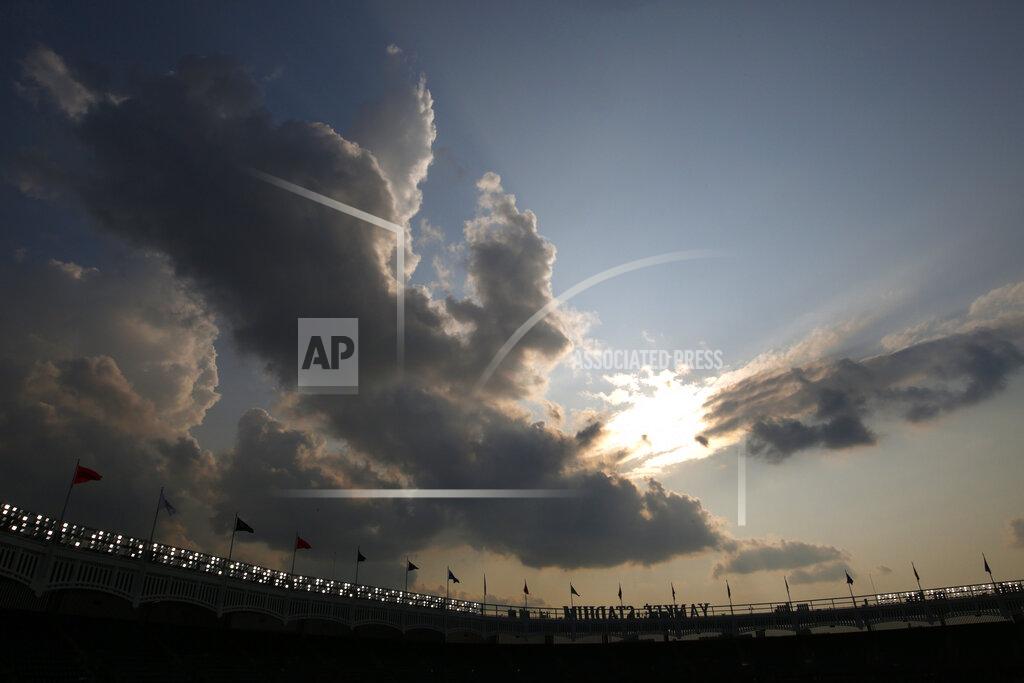 Adam Hunger A clearing sky appears over Yankee Stadium after a rain storm moved through clearing a haze of smoke before a baseball game between the Philadelphia Phillies and the New York Yankees, Wednesday, July 21, 2021, in New York. Wildfires in the American West, including one burning in Oregon that's currently the largest in the U.S., are creating hazy skies as far away as New York as the massive infernos spew smoke and ash into the air in columns up to six miles high. (AP Photo/Adam Hunger)