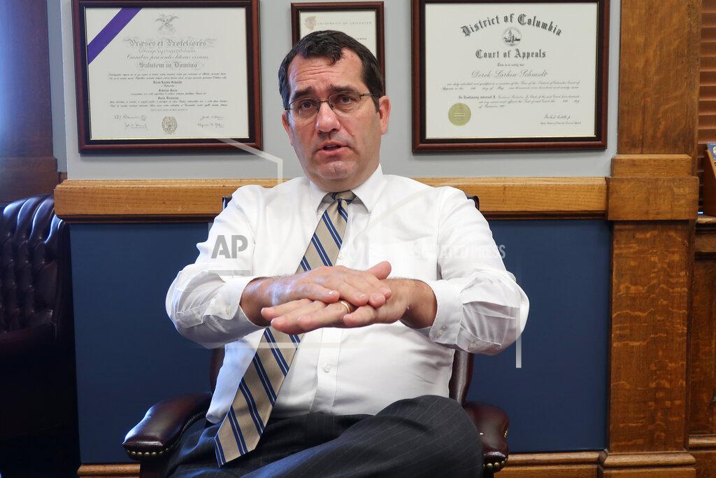 John Hanna Kansas Attorney General Derek Schmidt answers questions during an Associated Press interview in his office, Thursday, July 23, 2020, in Topeka, Kan. Schmidt says he believes both counties and local school districts can opt out of Gov. Laura Kelly's order requiring K-12 schools to have staff and students wear masks. (AP Photo/John Hanna)