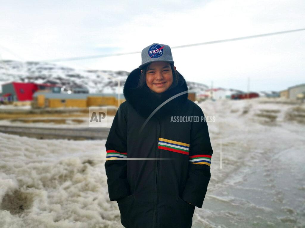 Aaron Watson In this May 7, 2020 photo provided by Aaron Watson, his son, Owen, 12, stands for a portrait in Iqaluit, the capital of Nunavut territory in far north Canada. Though there are no known cases of coronavirus in his town, Owen's school has closed as a precaution. He thinks it's only a matter of time before the virus arrives there. Iqaluit has a population of about 7,000 people, many of whom are Inuit. (Aaron Watson via AP)