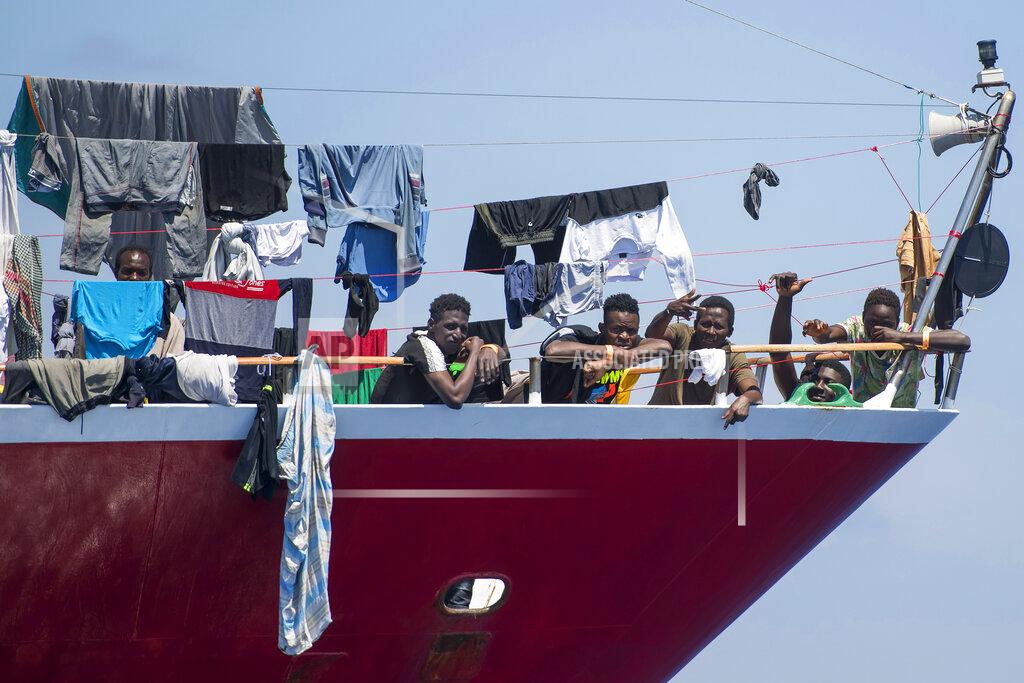 Rene' Rossignaud Migrants dry their clothes aboard a tourist boats some 20 kilometers from Malta, Tuesday, June 2, 2020. More than 400 migrants are living aboard pleasure cruise vessels, bobbing in the sea off Malta, many of them for weeks now. Rescued from human traffickers’ unseaworthy boats in several operations in the central Mediterranean since late April, the migrants, along with the Maltese government, are waiting for European Union countries to offer to take them. (AP Photo/Rene' Rossignaud)