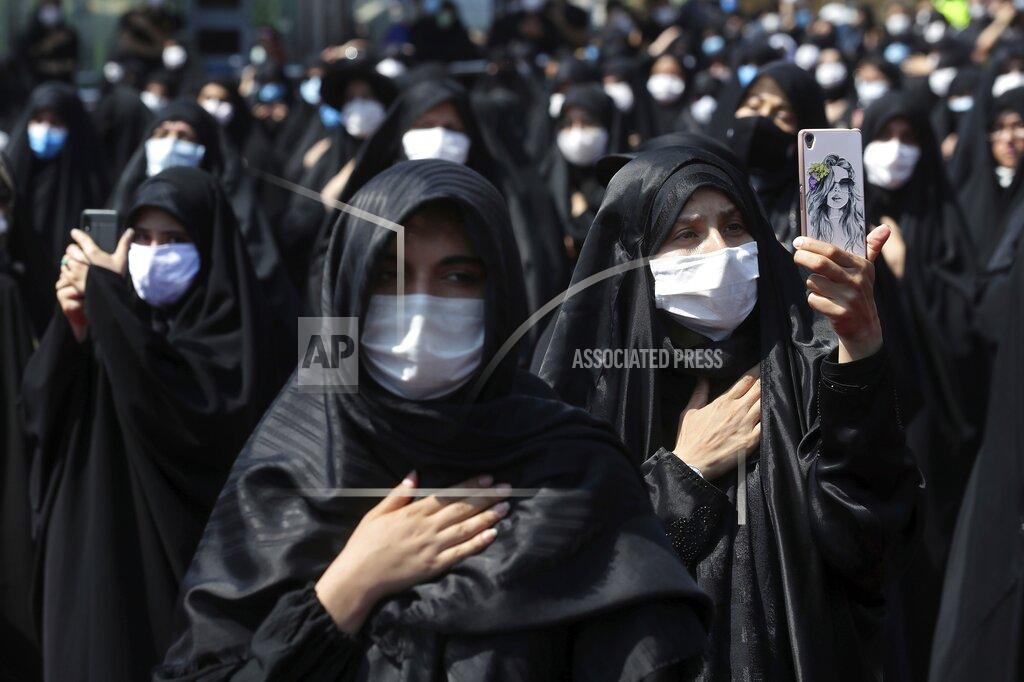 Ebrahim Noroozi FILE - In this Sunday, Aug. 30, 2020 file photo, people wearing protective face masks to help prevent spread of the coronavirus mourn during an annual ceremony commemorating Ashoura in Tehran, Iran. The confirmed death toll from the coronavirus has gone over 50,000 in the Middle East as the pandemic continues. That's according to a count Thursday, Sept. 3, 2020, from The Associated Press, based on official numbers offered by health authorities across the region. (AP Photo/Ebrahim Noroozi, File)