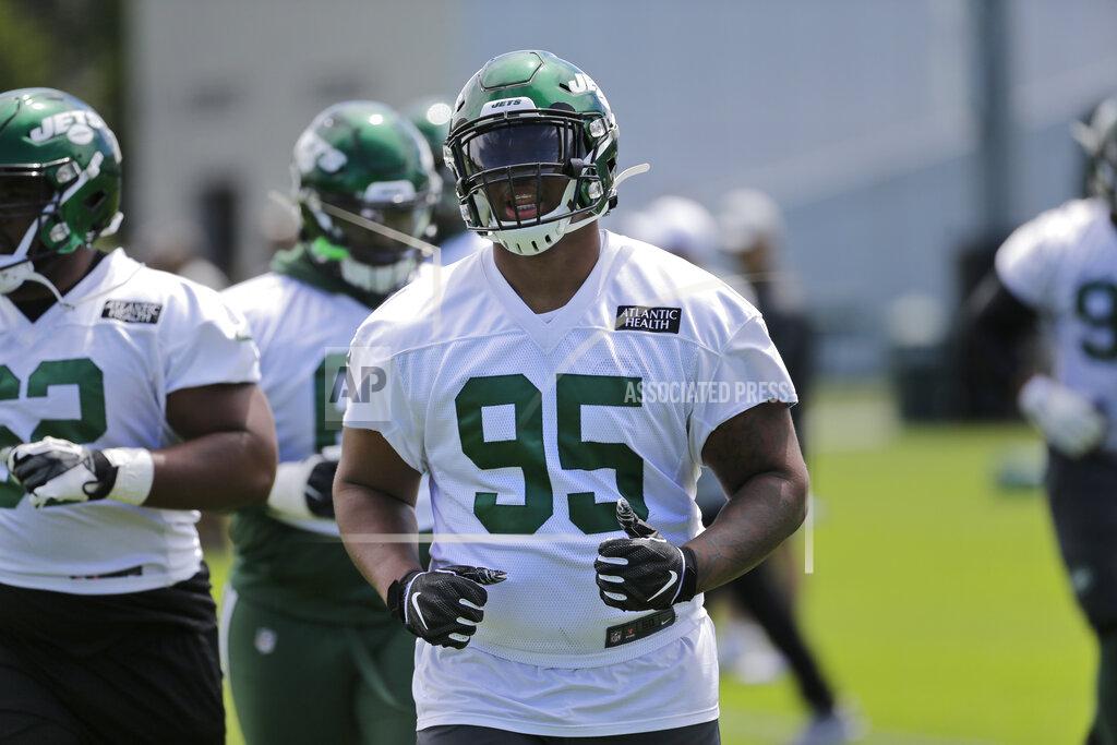 In this June 11, 2019 file photo New York Jets Quinnen Williams practices at the team's NFL football training facility in Florham Park, N.J. The Jets and Williams have agreed to terms on a four-year contract worth $32.5 million fully guaranteed.The former Alabama defensive tackle was the No. 3 overall selection in the NFL draft in April. He missed the Jets' first practice of training camp Thursday, July 25, 2019 but is expected to participate Friday. (AP Photo/Seth Wenig, file)