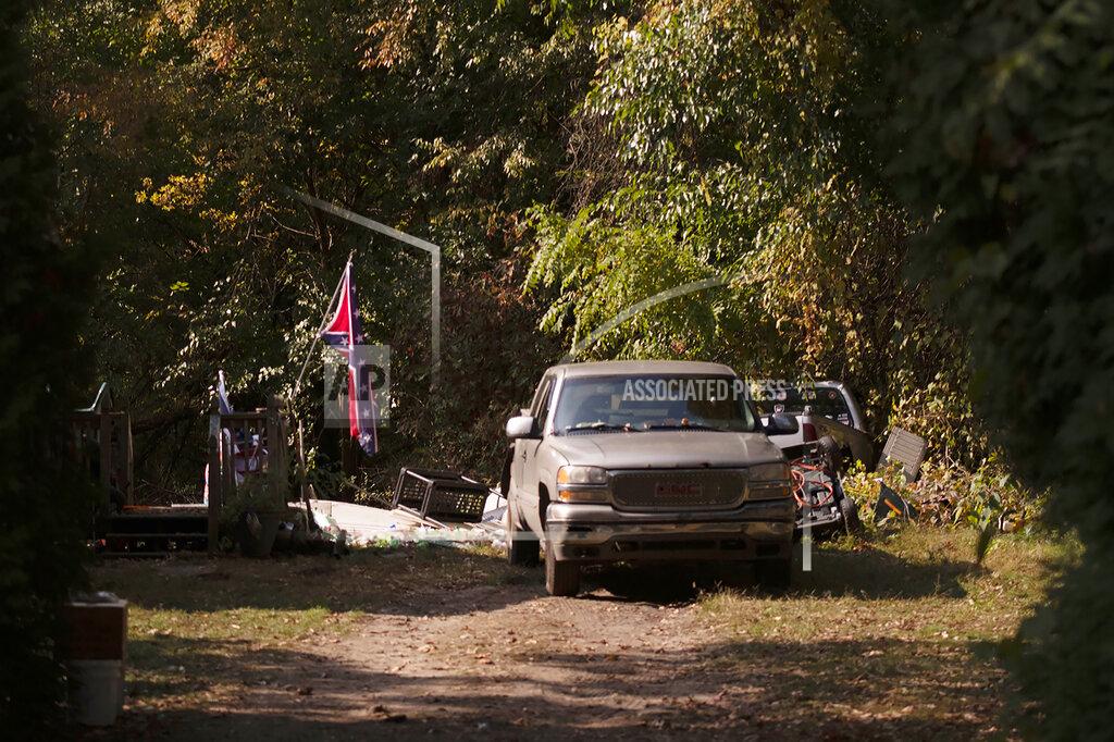 Nicole Hester A confederate flag hangs from a porch on a property in Munith, Mich., Friday, Oct. 9, 2020, where law enforcement officials said suspects accused in a plot to kidnap Michigan Democratic Gov. Gretchen Whitmer met to train and make plans. Pete Musico and Joseph Morrison, who officials said lived at the Munith property, have been charged in the plot. A federal judge said Friday, Oct. 16, 2020, prosecutors have enough evidence to move toward trial for five Michigan men accused of plotting to kidnap Democratic Gov. Gretchen Whitmer. (Nicole Hester/Ann Arbor News via AP)