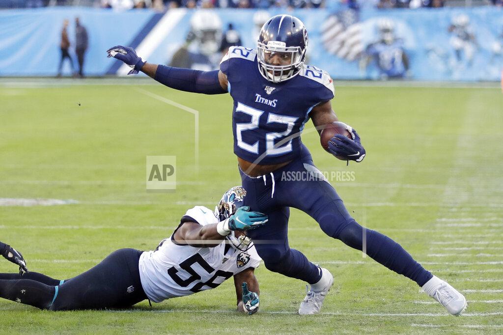 Tennessee Titans running back Derrick Henry (22) gets past Jacksonville Jaguars linebacker Quincy Williams (56) in the first half of an NFL football game Sunday, Nov. 24, 2019, in Nashville, Tenn. (AP Photo/James Kenney)