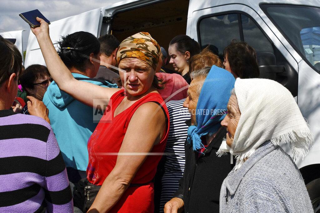 Andriy Andriyenko People receive humanitarian aid in the village of Andriivka, Donetsk region, Ukraine, Saturday, May 28, 2022. (AP Photo/Andriy Andriyenko)