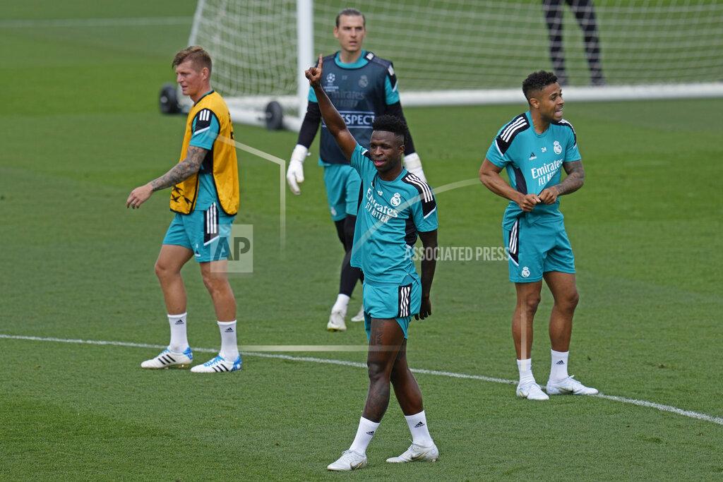Manu Fernandez Real Madrid's Vinicius Junior, centre, raises his arm during a Media Opening day training session in Madrid, Spain, Tuesday, May 24, 2022. Real Madrid will play Liverpool in Saturday's Champions League soccer final in Paris. (AP Photo/Manu Fernandez)
