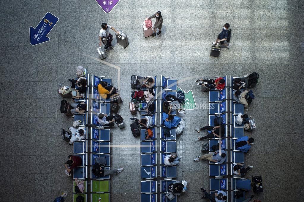 Uncredited Passengers wait for their train at the Hongqiao Railway Station in Shanghai, China Sunday, May 22, 2022. The locked-down Chinese metropolis of Shanghai opens some public transit services as it slowly eases pandemic restrictions that have kept most residents in their housing complexes for more than six weeks. (Chinatopix via AP)
