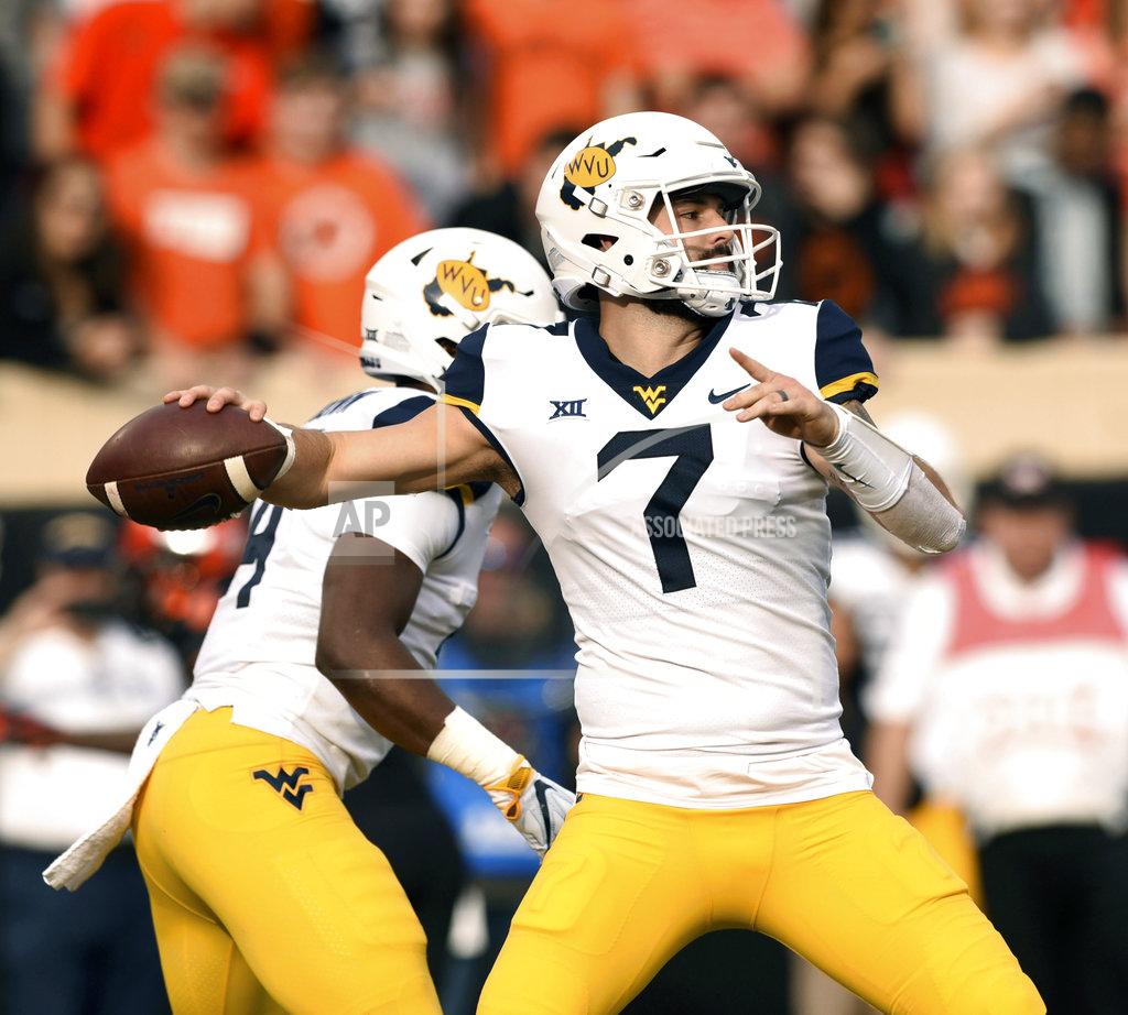 Brody Schmidt West Virginia quarterback Will Grier throws a pass during the first half of an NCAA college football game in Stillwater, Okla., Saturday, Nov. 17, 2018. Grier threw for 364 yards in the 41-45 loss to Oklahoma State. (AP Photo/Brody Schmidt)
