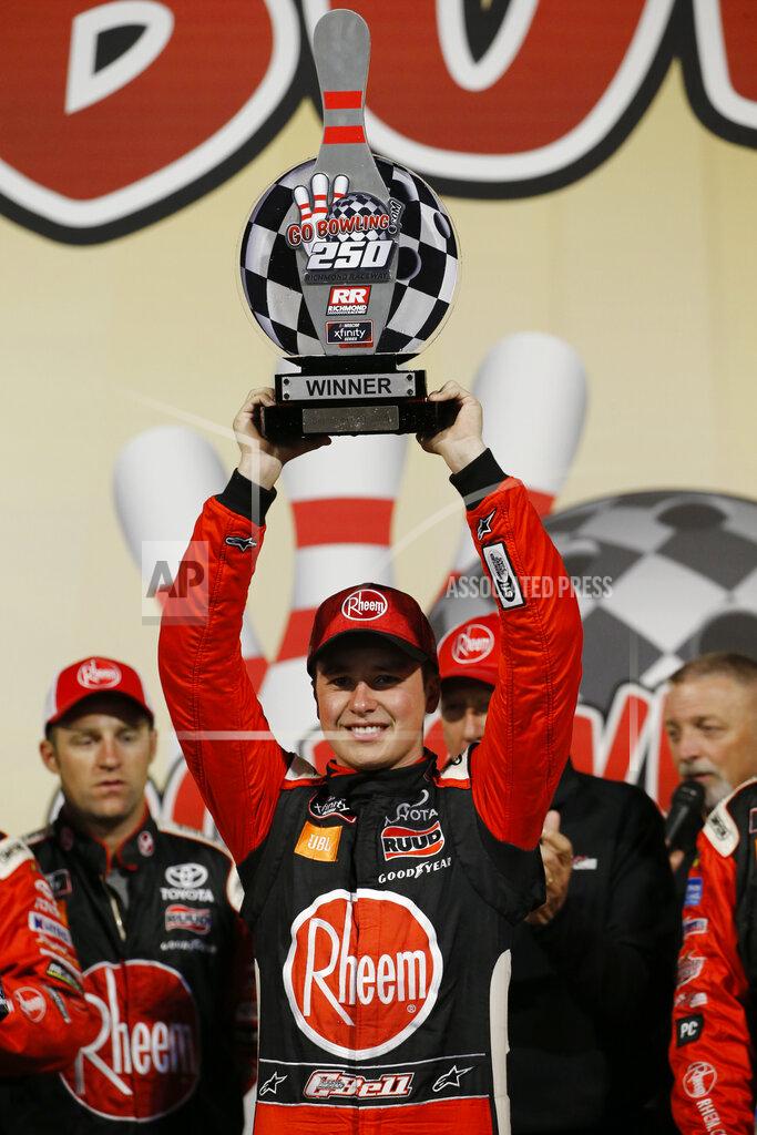 Steve Helber Christopher Bell holds the trophy as he celebrates his win in the NASCAR Xfinity Series auto race, in Victory Lane at Richmond Raceway in Richmond, Va., Friday, Sept. 20, 2019. (AP Photo/Steve Helber)
