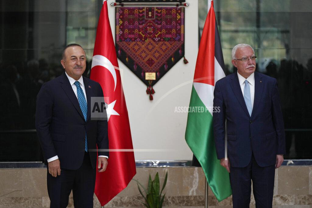 Majdi Mohammed Turkish Foreign Minister Mevlut Cavusoglu, left, poses for photographers with Palestinian Foreign Minister Riad al-Malki, in the West Bank town of Ramallah, Tuesday, May 24, 2022. (AP Photo/Majdi Mohammed)