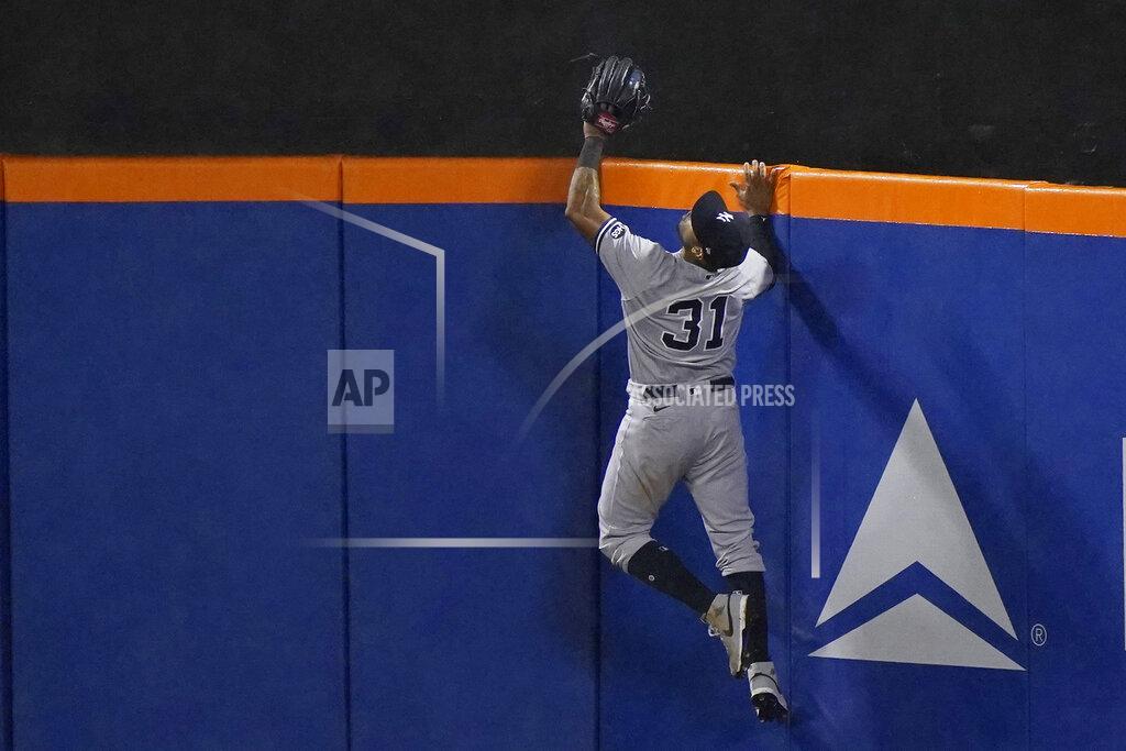 Kathy Willens New York Yankees center fielder Aaron Hicks (31) leaps in vain for a home run by New York Mets' J.D. Davis in the ninth inning of a makeup baseball game at Citi Field, Thursday, Sept. 3, 2020, in New York. (AP Photo/Kathy Willens)
