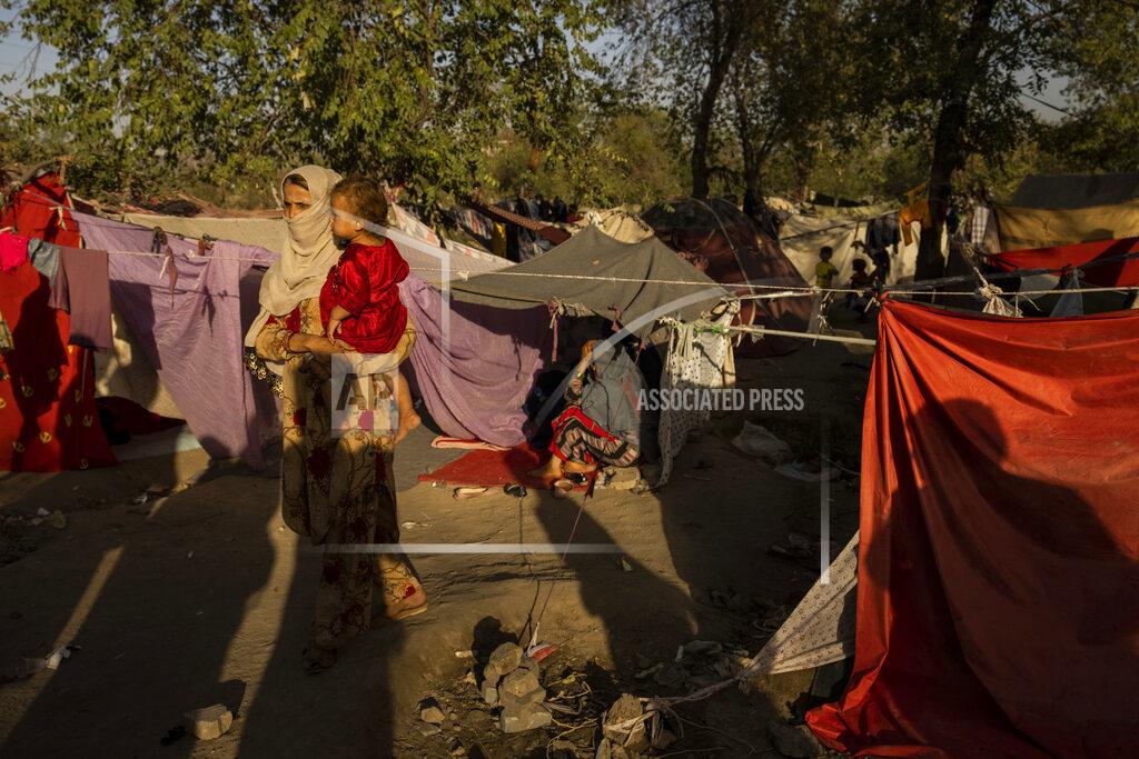 Bernat Armangue An internally displaced woman holds a child at an internally displaced camp in Kabul, Afghanistan, Monday, Sept. 13, 2021. A month after the fall of Kabul, the question of how the world will get aid to citizens without enriching Afghanistan's Taliban rulers is haunting the country. The stakes have soared for Afghans, who along with the threat of famine and a collapsing health care system face a looming crisis as winter approaches. (AP Photo/Bernat Armangue)