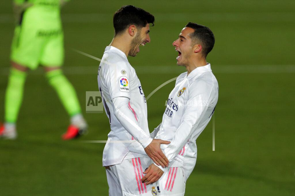 Manu Fernandez Real Madrid's Marco Asensio, left, celebrates with teammate Lucas Vazquez after scoring his side's second goal during the Spanish La Liga soccer match between Real Madrid and Celta Vigo at the Alfredo Di Stefano stadium in Madrid, Spain, Saturday, Jan. 2, 2021. (AP Photo/Manu Fernandez)
