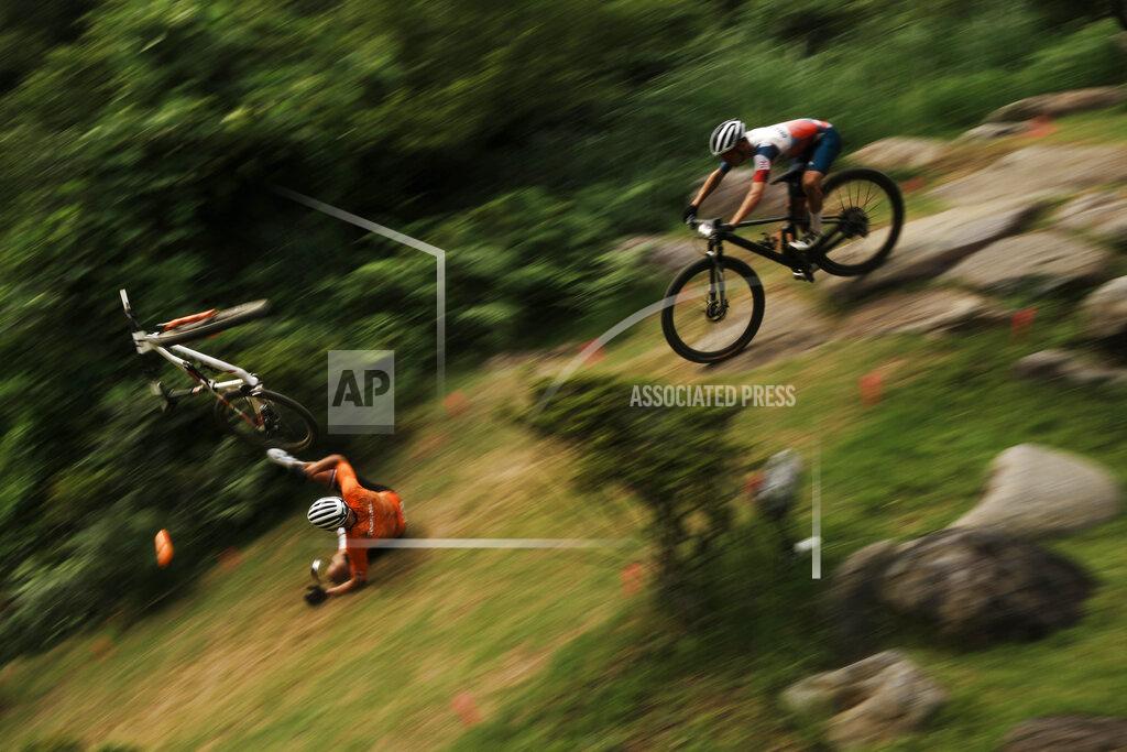 Thibault Camus Mathieu van der Poel of the Netherlands tumbles on a downhill during the men's cross country mountain bike competition at the 2020 Summer Olympics, Monday, July 26, 2021, in Izu, Japan. (AP Photo/Thibault Camus)
