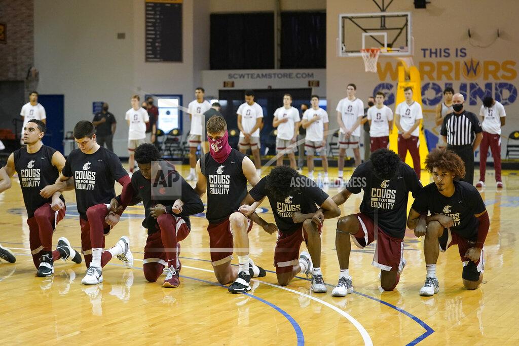 Jeff Chiu Washington State players kneel during the national anthem in front of standing Stanford players before an NCAA college basketball game in Santa Cruz, Calif., Saturday, Jan. 9, 2021. (AP Photo/Jeff Chiu)