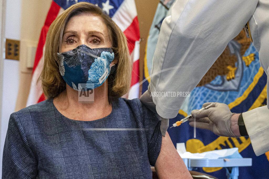 FILE - In this Friday, Dec. 18, 2020, file photo, Speaker of the House Nancy Pelosi, D-Calif., receives a Pfizer-BioNTech COVID-19 vaccine shot from Dr. Brian Monahan, the Capitol physician, in Washington. On Thursday, Dec. 24, 2020, The Associated Press reported on stories circulating online incorrectly asserting that the doctor never removed a cap from the syringe, so she never actually received the shot. Photos and news reports clearly document every step of the process of her successfully receiving the injection. (Ken Cedeno/Pool via AP)