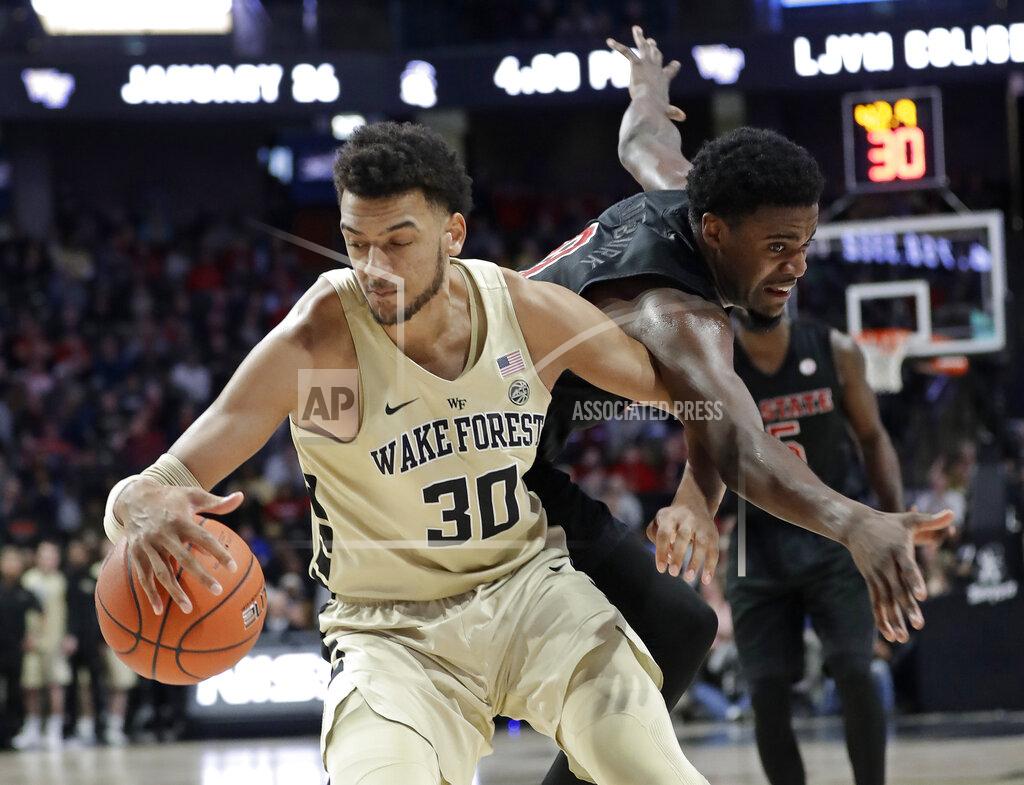 Chuck Burton Wake Forest's Olivier Sarr (30) grabs a loose ball in front of North Carolina State's DJ Funderburk (0) during the second half of an NCAA college basketball game in Winston-Salem, N.C., Tuesday, Jan. 15, 2019. (AP Photo/Chuck Burton)