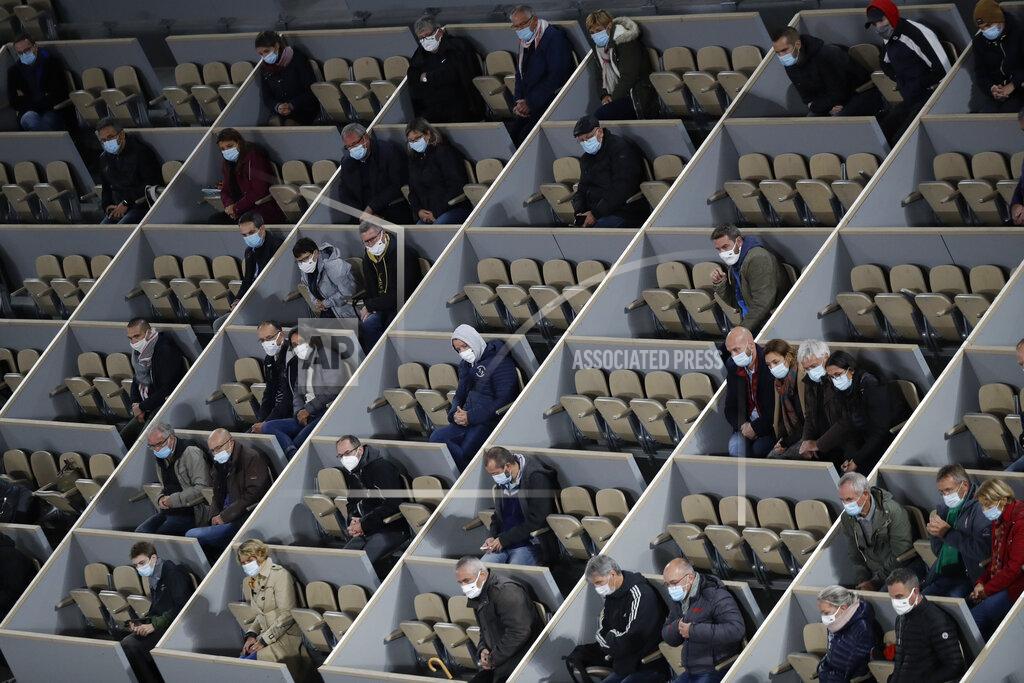 Alessandra Tarantino Spectators watch Austria's Dominic Thiem and Croatia's Marin Cilic play their first round match of the French Open tennis tournament in center court Philippe Chatrier at the Roland Garros stadium in Paris, France, Monday, Sept. 28, 2020. (AP Photo/Alessandra Tarantino)
