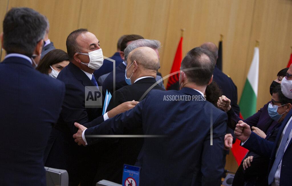 Virginia Mayo A group of NATO foreign ministers, right, reach out to greet Turkish Foreign Minister Mevlut Cavusoglu, center left, with a fist bump during a meeting of NATO foreign ministers at NATO headquarters in Brussels on Tuesday, March 23, 2021. (AP Photo/Virginia Mayo, Pool)