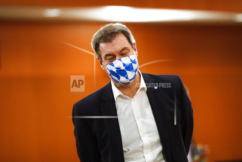 Markus Schreiber File - In this Wednesday, June 17, 2020 file photo Bavarian Prime Minister Markus Soeder of the Christian Social Union, CSU, party, wears a face mask with Bavarian's white and blue diamond pattern as he arrives for a meeting with German Chancellor Angela Merkel and German federal states governors at the chancellery in Berlin, Germany. German Chancellor Angela Merkel's center-right party, the Christian Democratic Union, CDU, is choosing a new leader on the weekend Saturday Jan. 16 and Sunday Jan. 17, 2021, a decision that will help determine who succeeds Merkel at the helm of the European Union's biggest economy after a 16-year reign. (AP Photo/Markus Schreiber, Pool, file)