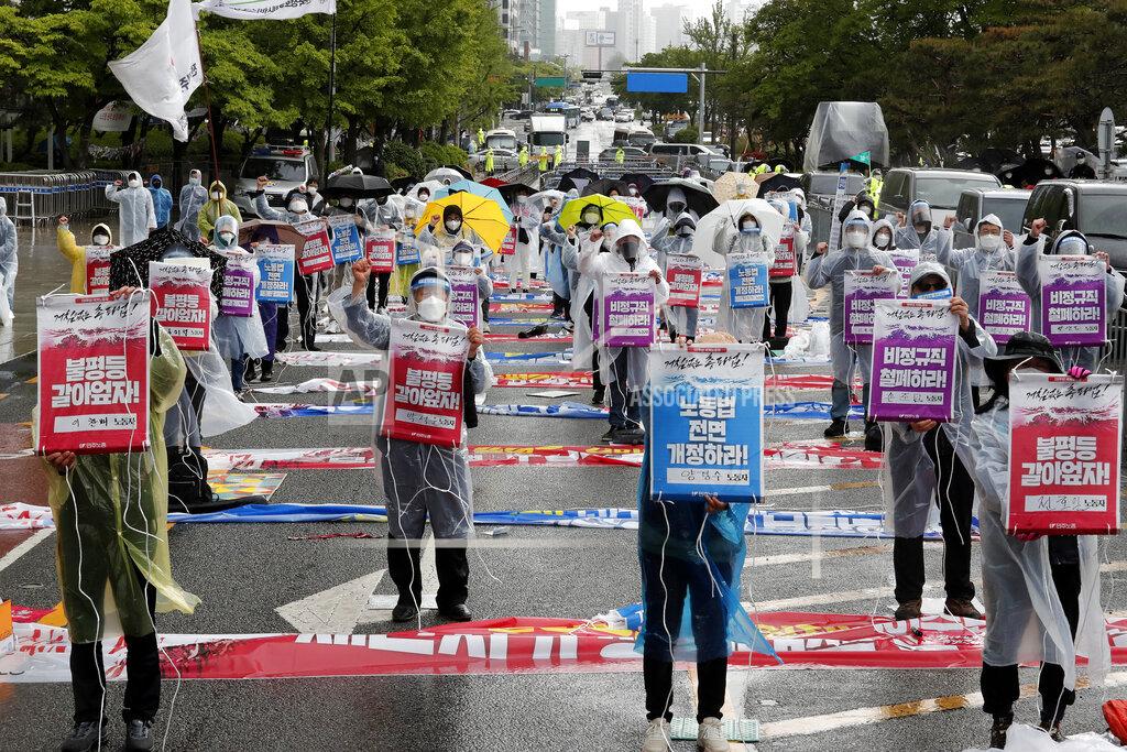 Ahn Young-Joon Members of the Korean Confederation of Trade Unions stage a May Day rally demanding better working conditions and expanding labor rights in Seoul, South Korea, Saturday, May 1, 2021. The signs read: "Let's solve inequality." (AP Photo/Ahn Young-joon)