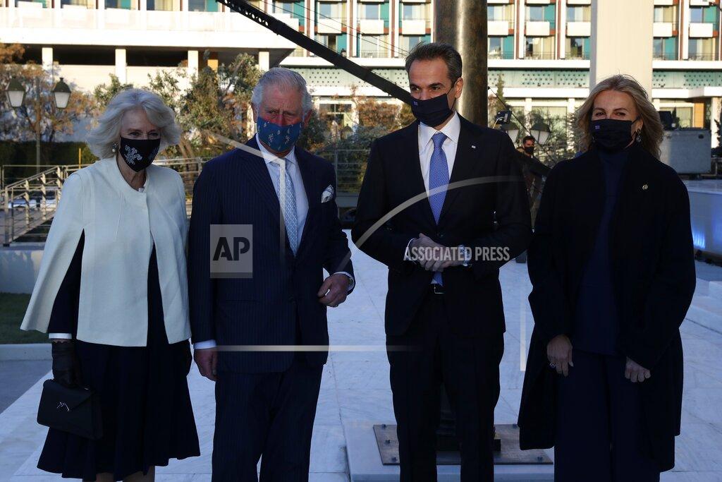 Yorgos Karahalis Greece's Prime Minister Kyriakos Mitsotakis, second right, and his wife Mareva Grabowski, right, Britain's Prince Charles, second left, and his wife Camilla, the Duchess of Cornwall, left, pose for the photographers at Greece's newly renovated National Gallery in Athens, Wednesday, March 24, 2021. Greece on Wednesday kicked off two days of celebrations to mark the bicentenary of the start of the country's war of independence, although events are far more muted than originally planned due to the pandemic. (AP Photo/Yorgos Karahalis)