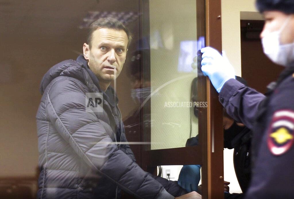 Uncredited In this image made from video provided by the Babuskinsky District Court, Russian opposition leader Alexei Navalny stands in a cage during a hearing on his charges for defamation, in the Babuskinsky District Court in Moscow, Russia, Friday, Feb. 5, 2021. Navalny was accused of slandering a World War II veteran featured in the video promoting the constitutional reform allowing to extend President Vladimir Putin's rule. The politician slammed people in the video as "corrupt stooges" and "traitors." (Babuskinsky District Court via AP)