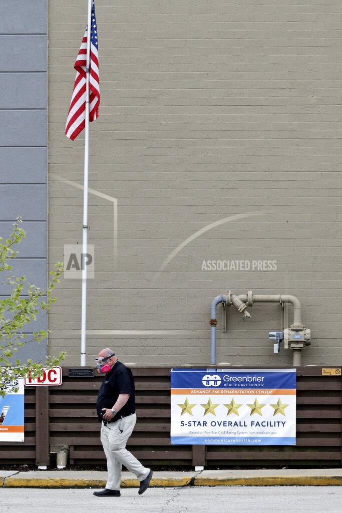 Tony Dejak A man walks out of Greenbrier Health Center, Tuesday, May 19, 2020, in Parma Heights, Ohio. The number of deaths from the coronavirus in Ohio's nursing homes is now over 1,000. That means long-term centers account for three out of five deaths from the virus in the state. Greenbrier has at least 24 cumulative resident cases and 12 cumulative staff cases. (AP Photo/Tony Dejak)
