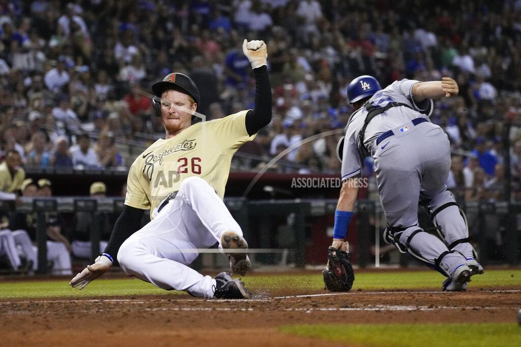 Rick Scuteri Arizona Diamondbacks' Pavin Smith (26) scores a run behind Los Angeles Dodgers catcher Will Smith on a ball hit by Josh VanMeter in the fifth inning during a baseball game, Friday, Sept. 24, 2021, in Phoenix. (AP Photo/Rick Scuteri)