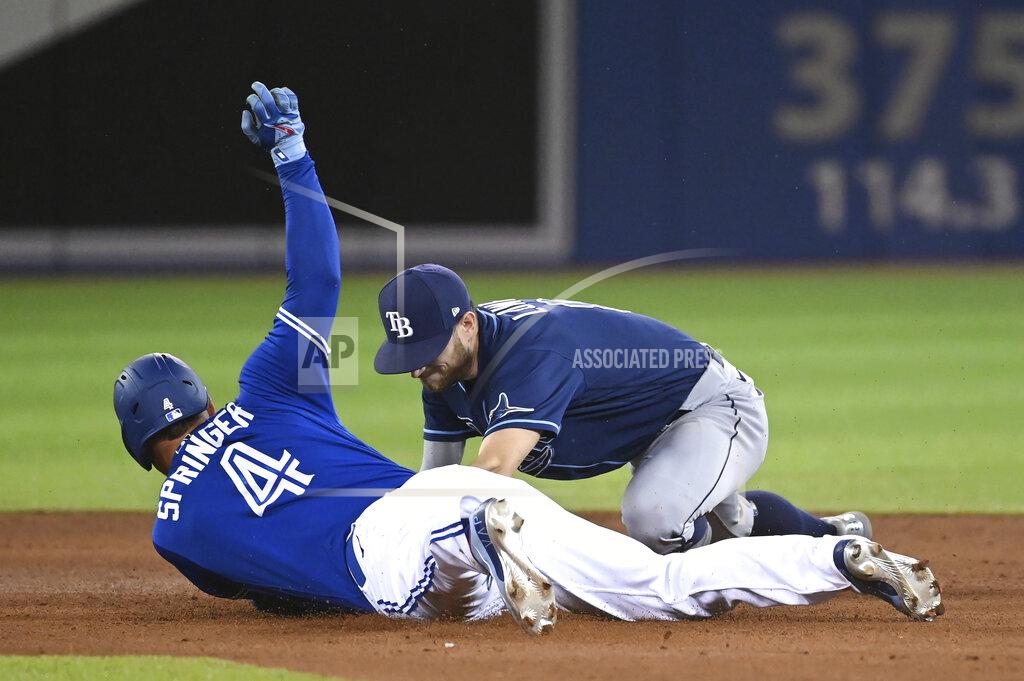 Jon Blacker Toronto Blue Jays' George Springer (4) slides into second base with a double ahead of the tag by Tampa Bay Rays' Brandon Lowe during the fourth inning of a baseball game Tuesday, Sept. 14, 2021, in Toronto. (Jon Blacker/The Canadian Press via AP)