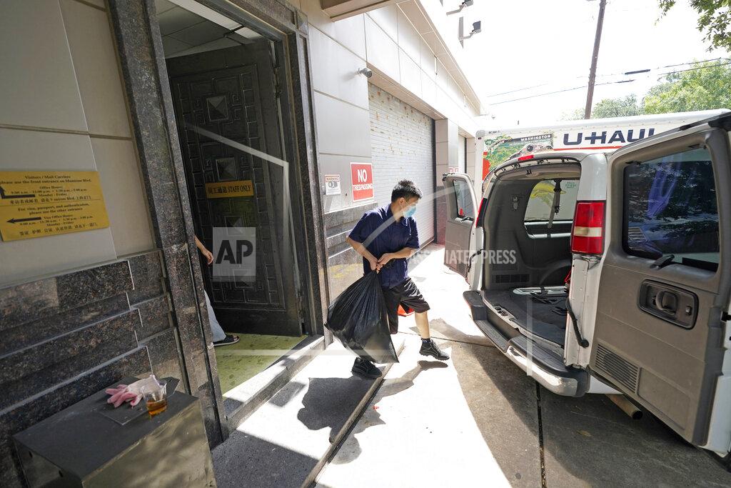 David J. Phillip A man loads the back of a van with a bag from inside the Chinese Consulate Thursday, July 23, 2020, in Houston. China says “malicious slander" is behind an order by the U.S. government to close its consulate in Houston, and maintains that its officials have never operated outside ordinary diplomatic norms. (AP Photo/David J. Phillip)