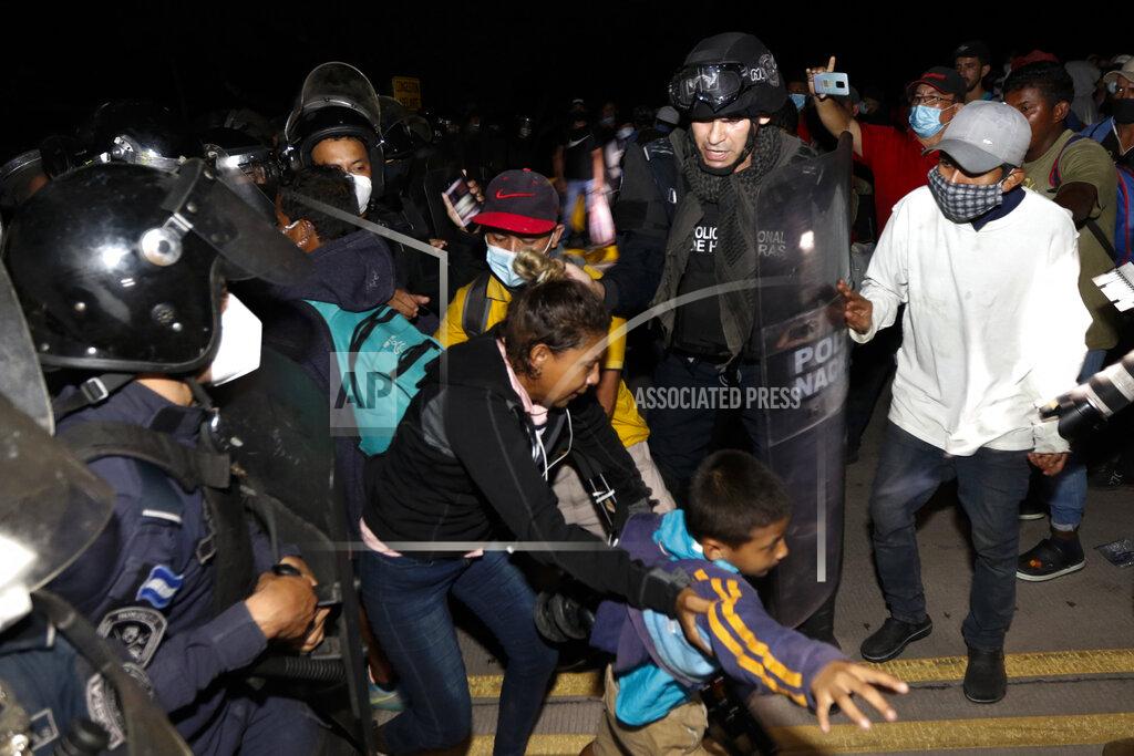 Delmer Martinez Honduran security forces try to keep back migrants from crossing the border into Guatemala, in El Florido, Honduras, Friday, Jan. 15, 2021. More than 1,000 Honduran migrants pushed their way into Guatemala Friday night without registering, a portion of a larger migrant caravan that had left the Honduran city of San Pedro Sula before dawn, Guatemalan authorities said. (AP Photo/Delmer Martinez)